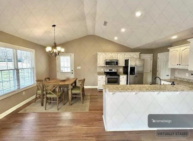 kitchen with stainless steel appliances, white cabinetry, hanging light fixtures, and dark hardwood / wood-style flooring