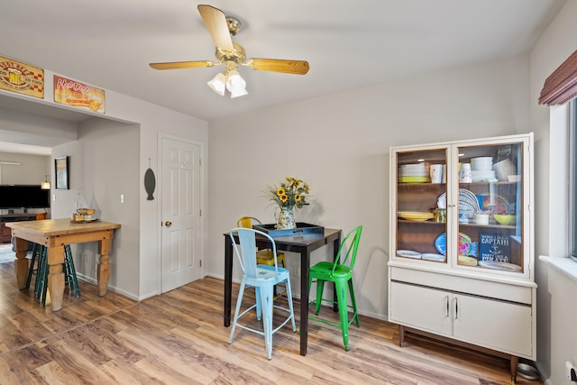 dining area with hardwood / wood-style flooring and ceiling fan