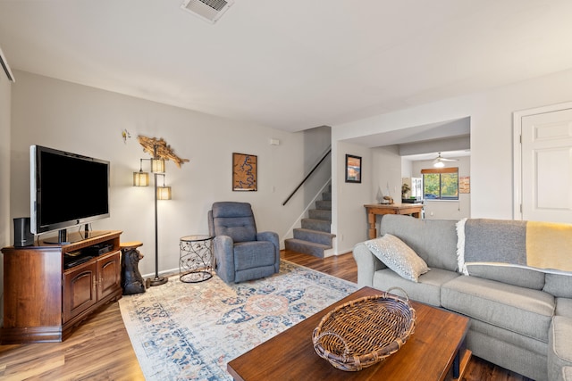 living room featuring light hardwood / wood-style floors and ceiling fan