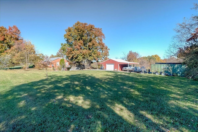 view of yard with a garage and an outdoor structure