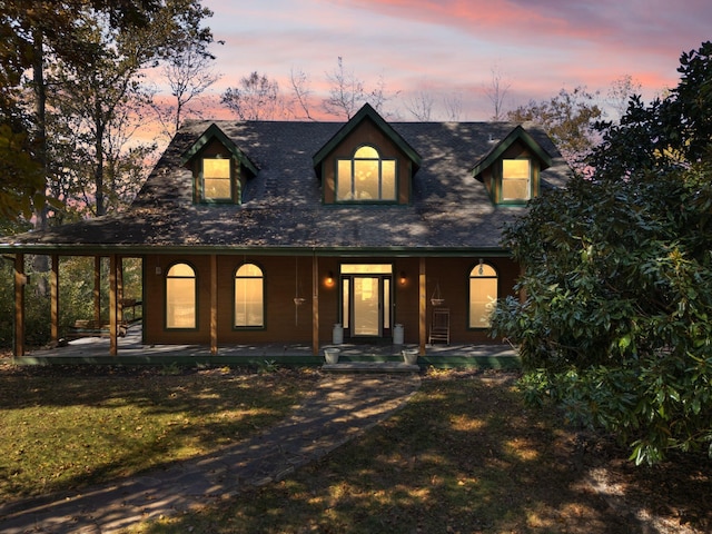 view of front of house with a yard and covered porch