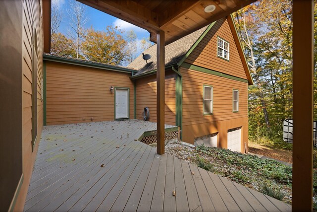 wooden terrace featuring a garage