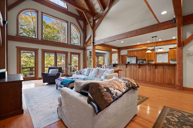 living area with high vaulted ceiling, light wood finished floors, beamed ceiling, and recessed lighting