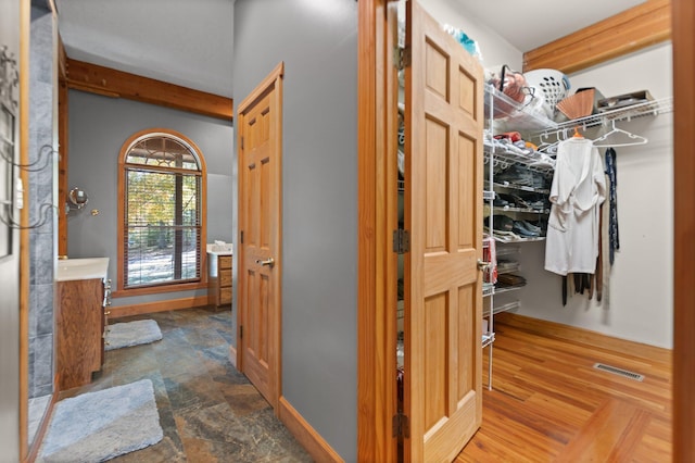 interior space with stone finish floor, visible vents, and baseboards