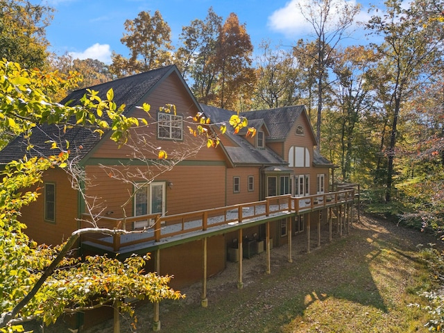 rear view of house featuring a wooden deck