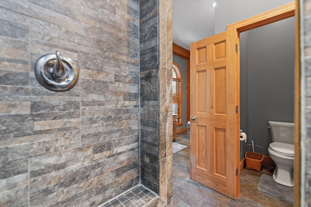 270 Wondering Woods Dr, Somerset, KY 42503 - bathroom featuring toilet, stone finish flooring, and a shower