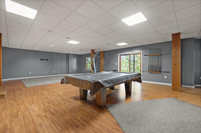 game room featuring light wood-type flooring and a paneled ceiling