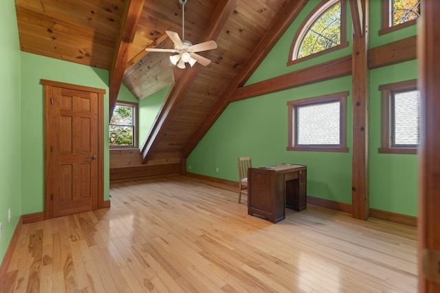 bonus room featuring light wood-type flooring, vaulted ceiling with beams, plenty of natural light, and baseboards