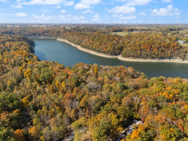 aerial view featuring a forest view and a water view