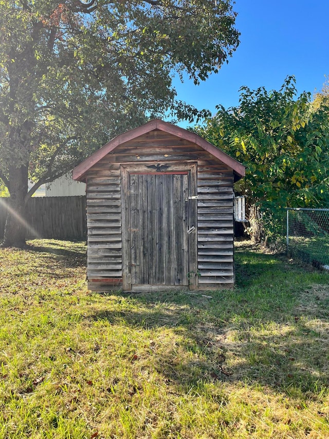 view of outbuilding featuring a yard