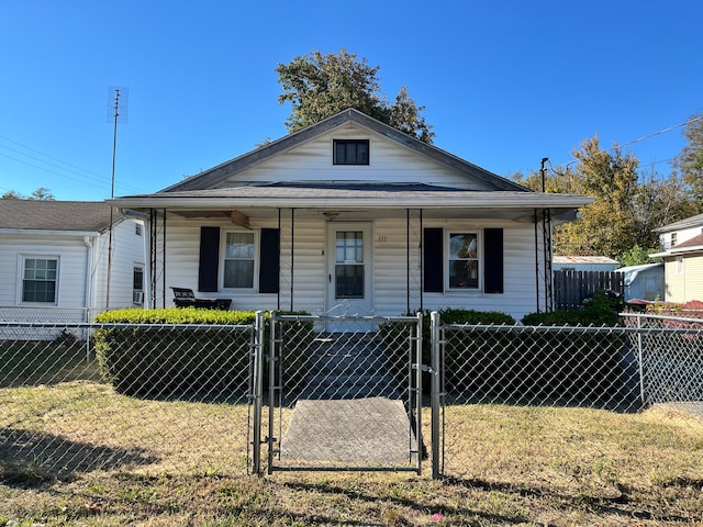 bungalow-style house with a porch and a front lawn