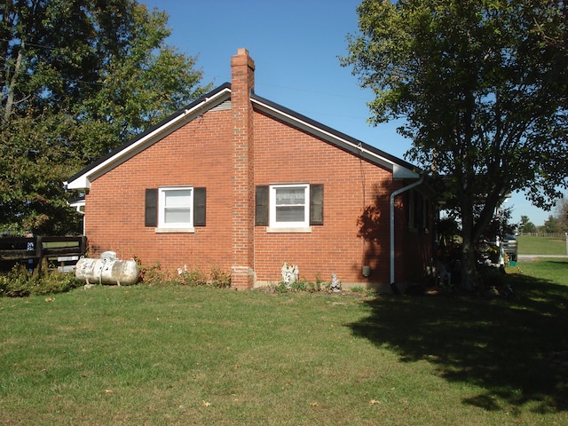 view of home's exterior with a yard