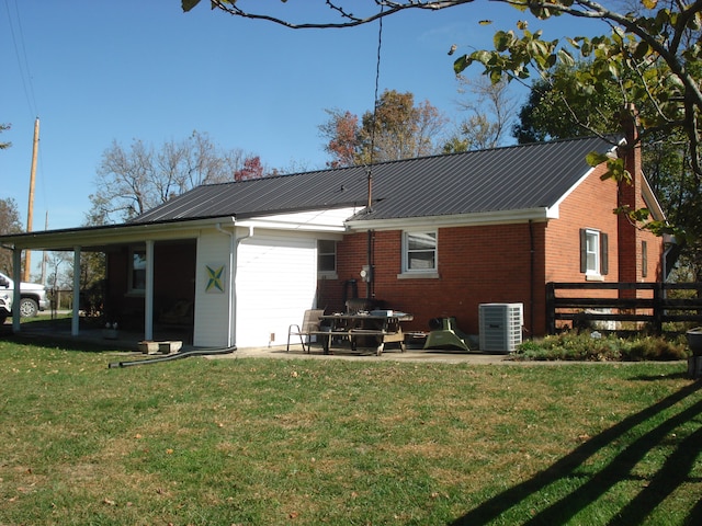 back of property featuring a yard and cooling unit