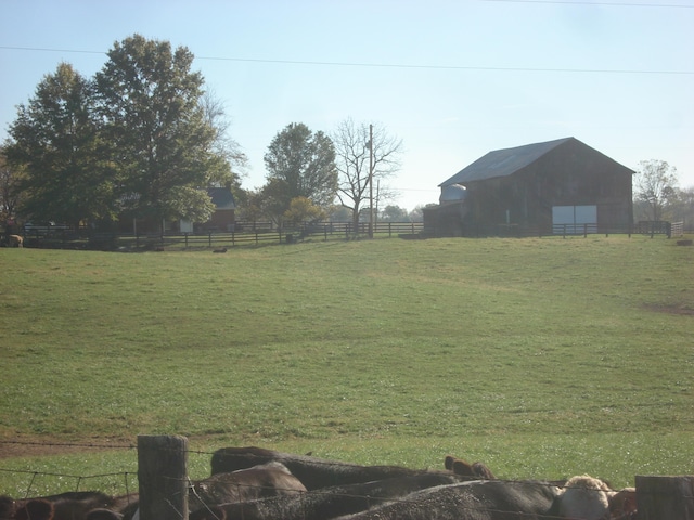 view of yard with an outbuilding and a rural view