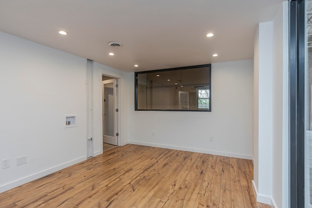 empty room with light hardwood / wood-style flooring