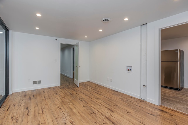 unfurnished room with light hardwood / wood-style flooring