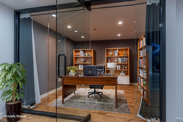 home office with light hardwood / wood-style floors