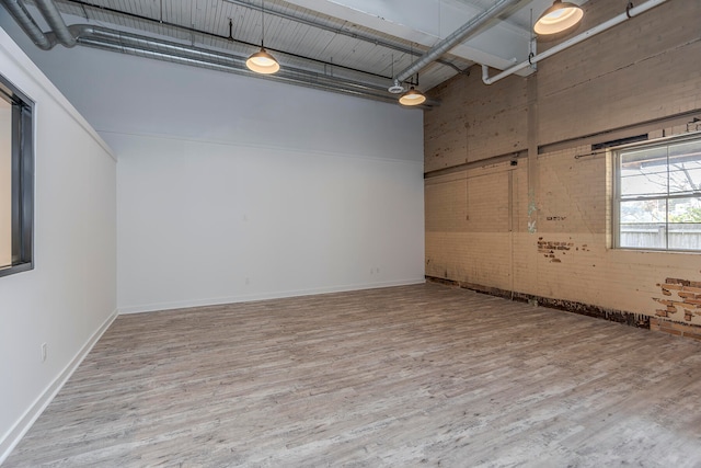 spare room with a high ceiling and hardwood / wood-style flooring