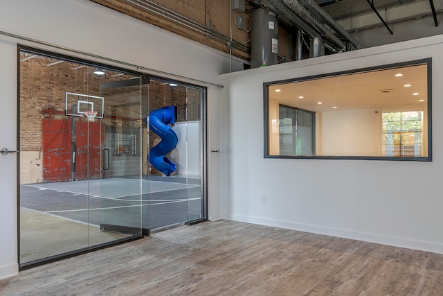 empty room featuring hardwood / wood-style flooring and a towering ceiling