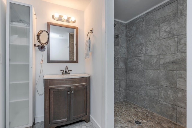 bathroom with vanity and a tile shower