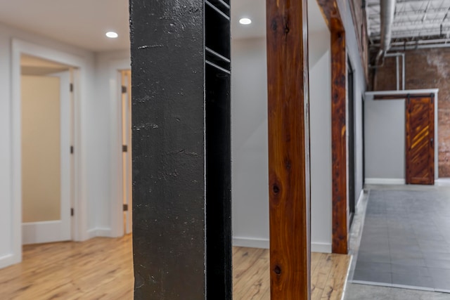 hallway with light hardwood / wood-style floors