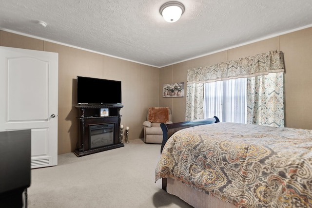 bedroom featuring crown molding, carpet, and a textured ceiling