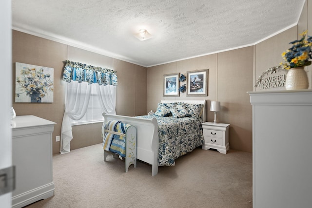 carpeted bedroom with ornamental molding and a textured ceiling