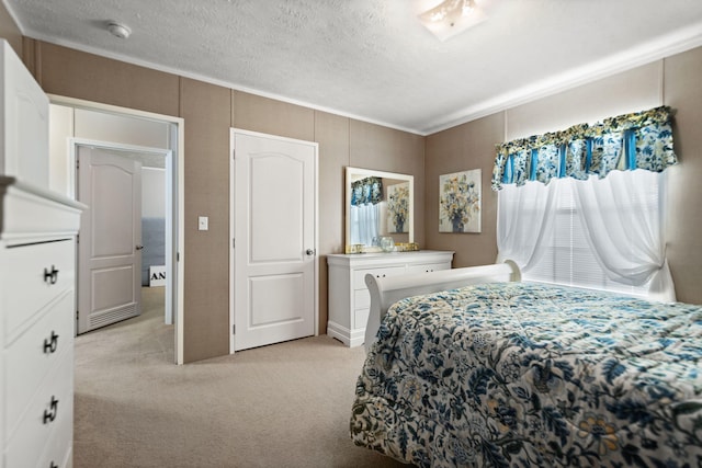 bedroom featuring a textured ceiling and light colored carpet