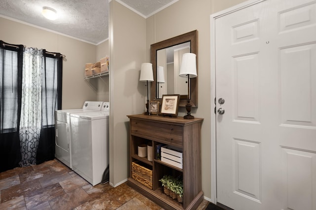 laundry room with ornamental molding, independent washer and dryer, and a textured ceiling