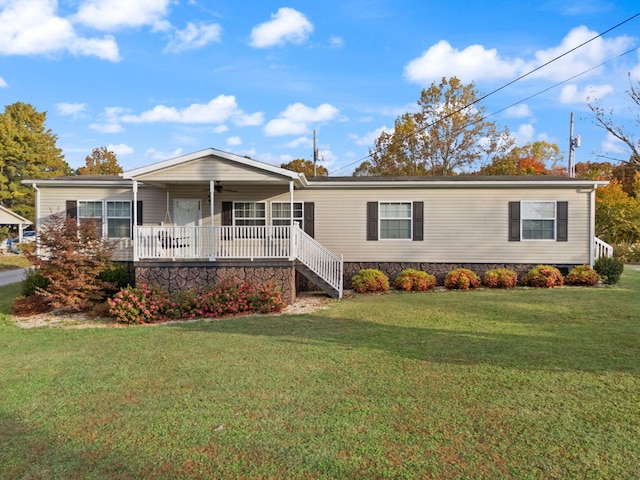 view of front facade with a front yard and a deck