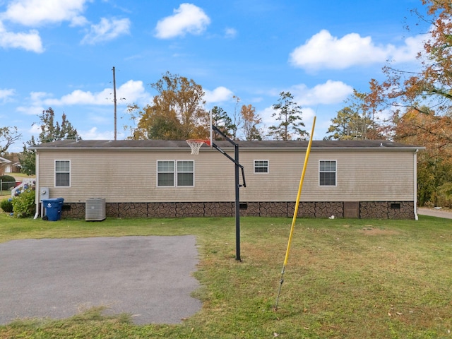 view of home's exterior featuring a yard and central AC unit