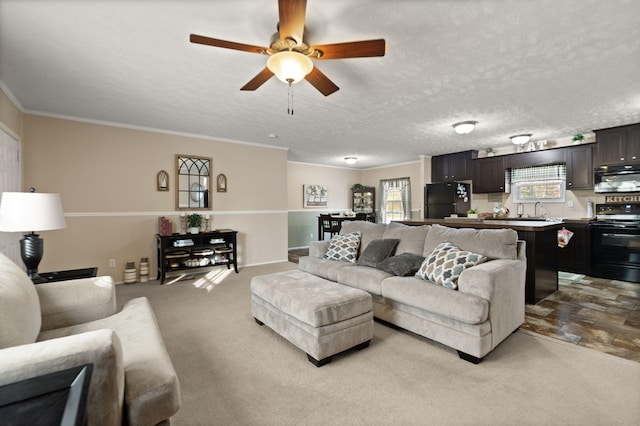 living room with a textured ceiling, light colored carpet, and ceiling fan