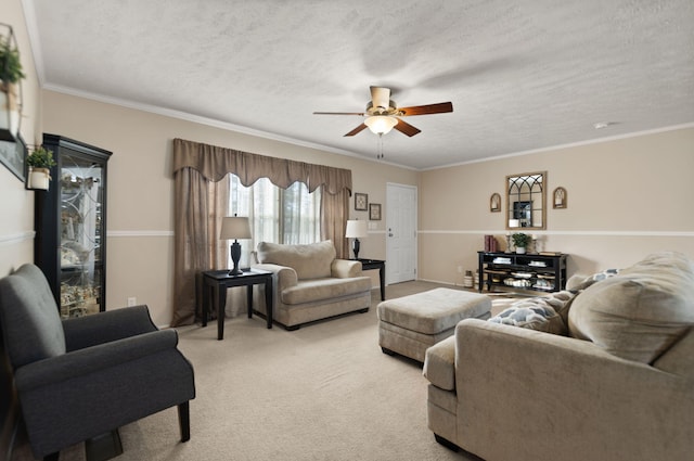 living room featuring crown molding, a textured ceiling, light colored carpet, and ceiling fan