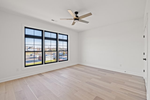 spare room featuring light hardwood / wood-style flooring and ceiling fan