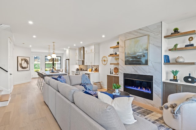 living room featuring a fireplace and light hardwood / wood-style floors