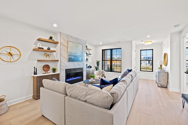 living room with a fireplace and light hardwood / wood-style floors