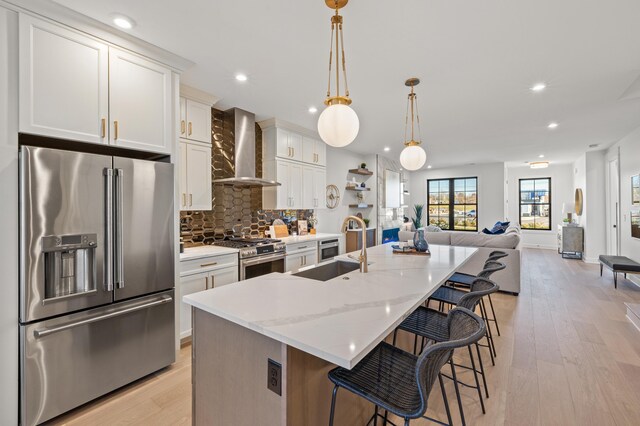 4181 Cocos Way, Lexington, KY 40513 - kitchen with a kitchen breakfast bar, a sink, backsplash, wall chimney range hood, and appliances with stainless steel finishes
