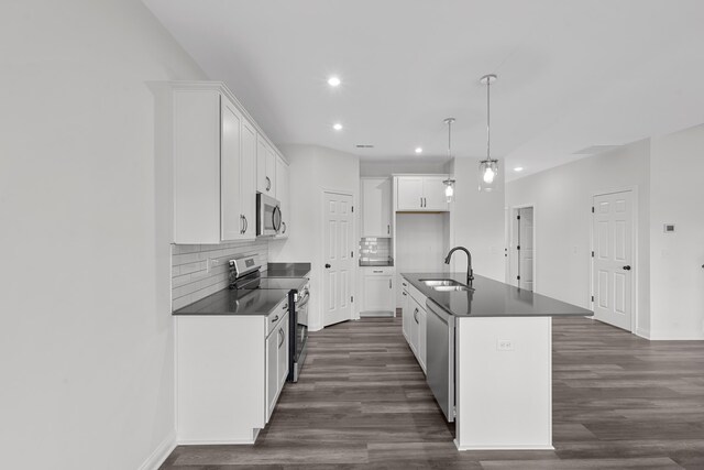 148 Nuthatch Trl, Georgetown, KY 40324 - kitchen with stainless steel appliances, dark countertops, a sink, dark wood finished floors, and recessed lighting