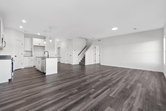148 Nuthatch Trl, Georgetown, KY 40324 - unfurnished living room featuring a sink, stairs, dark wood-style floors, recessed lighting, and baseboards