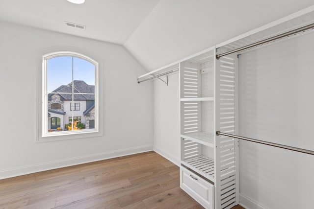 walk in closet featuring lofted ceiling and light wood-type flooring