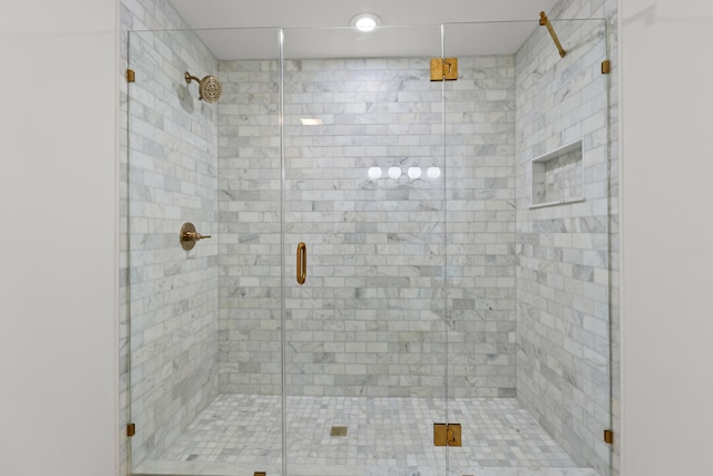 bathroom featuring a shower with door