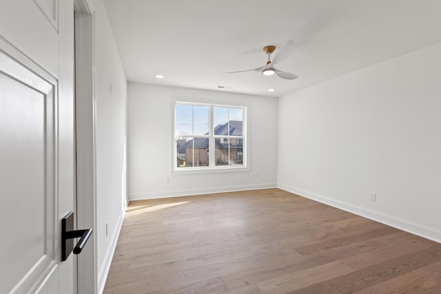 unfurnished room with light wood-type flooring and ceiling fan