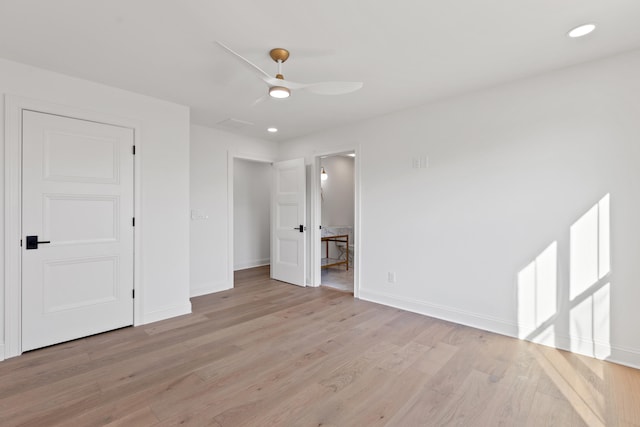 unfurnished bedroom with light hardwood / wood-style flooring, connected bathroom, and ceiling fan