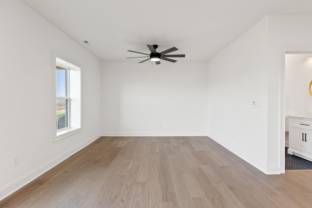 spare room featuring light wood-type flooring and ceiling fan