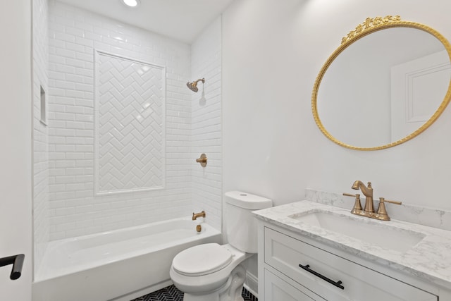 full bathroom featuring vanity, tiled shower / bath, and toilet