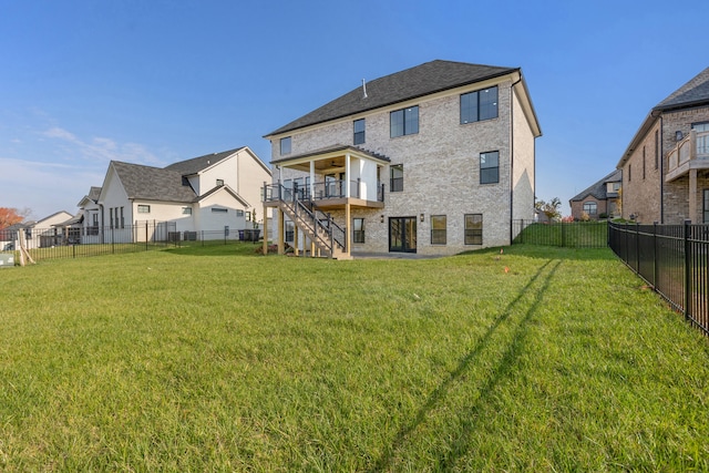 rear view of house featuring a lawn