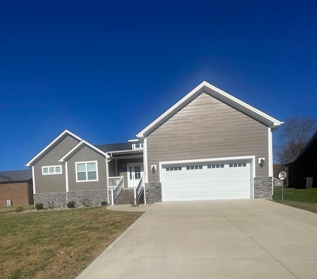 craftsman-style home with a porch, a front lawn, and a garage