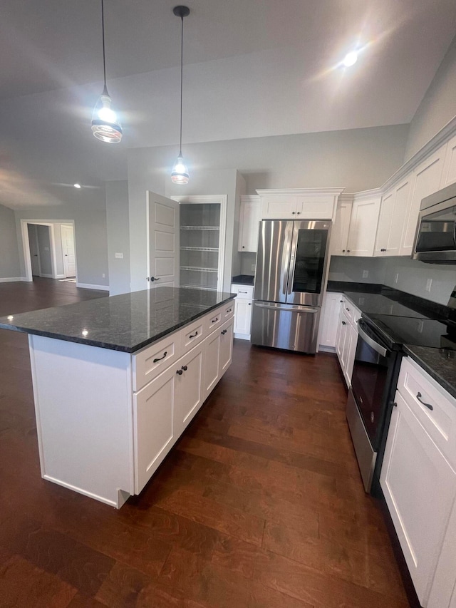 kitchen with white cabinets, dark stone countertops, dark wood-type flooring, pendant lighting, and stainless steel appliances