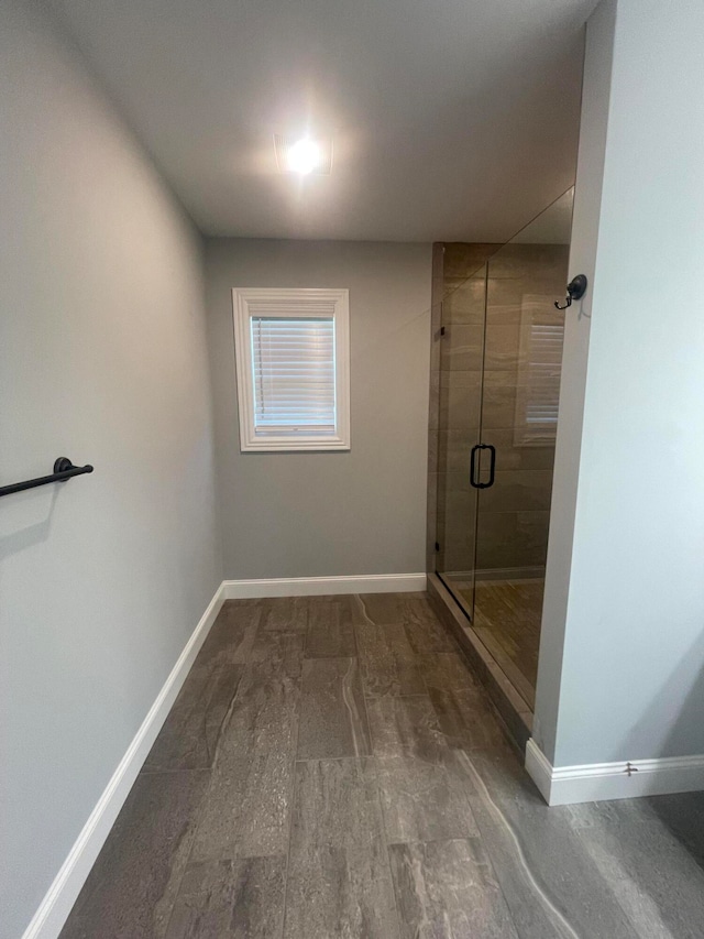 bathroom featuring a shower with door and hardwood / wood-style floors