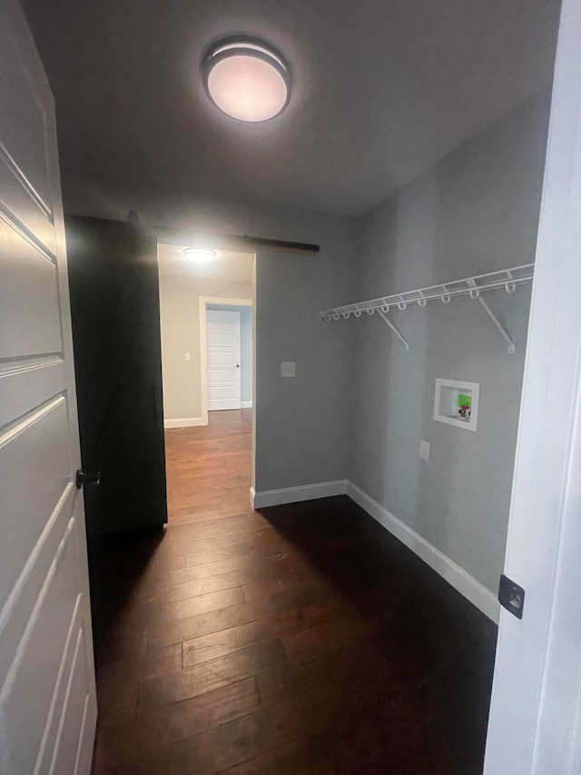 washroom featuring hookup for a washing machine and dark hardwood / wood-style floors